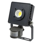 Black LED security floodlight with yellow bulb and motion sensor mounted on bracket, product photo on white background.