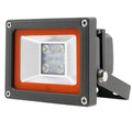 Philips LED flood light with gray housing, orange trim, and integrated motion sensor bracket, mounted at angle.