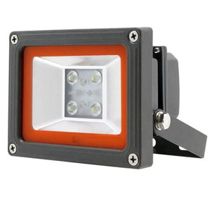 Philips LED flood light with gray housing, orange trim, and integrated motion sensor bracket, mounted at angle.