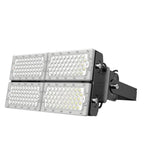 Industrial LED flood light with four rectangular panels containing white bulbs, mounted on black adjustable bracket against w