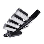 Black adjustable LED flood light with five tilting panels and heatsink fins, shown at an angle against a white background.
