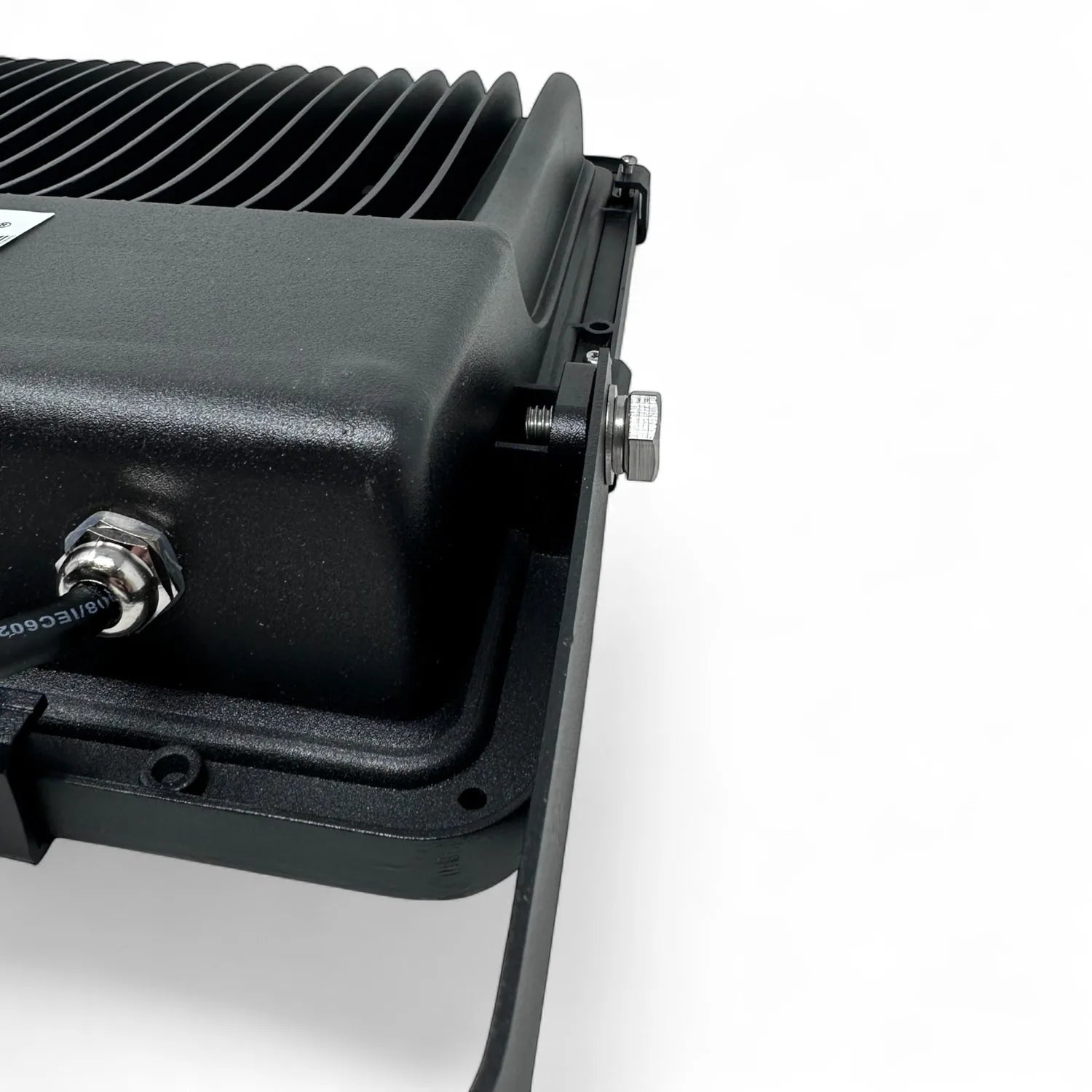 Close-up of black LED floodlight showing finned heat sink, mounting bracket, and cable connector against white background.