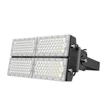 Modular LED flood light with four rectangular panels containing LED arrays, mounted on black bracket housing against white ba