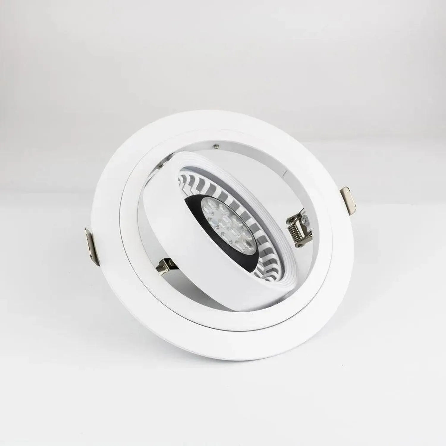 White round LED gimbal recessed light fixture with adjustable black and silver spotlight head, shown against white background