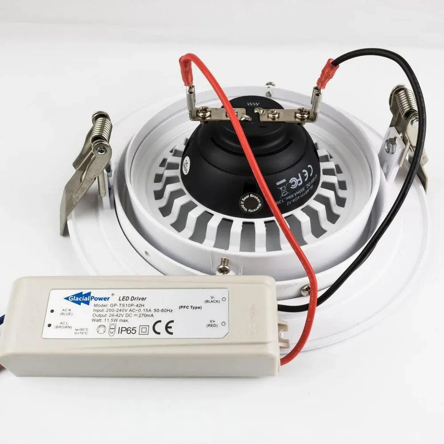 Glacial Power LED driver with white housing connected to circular recessed light fixture via red and black wires, showing spe