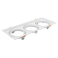 White rectangular triple recessed light fixture with three circular gimbal housings and orange adjustment clips, product shot