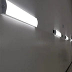 LED ceiling light installation shot showing one large rectangular fixture mounted above and three smaller matching fixtures o