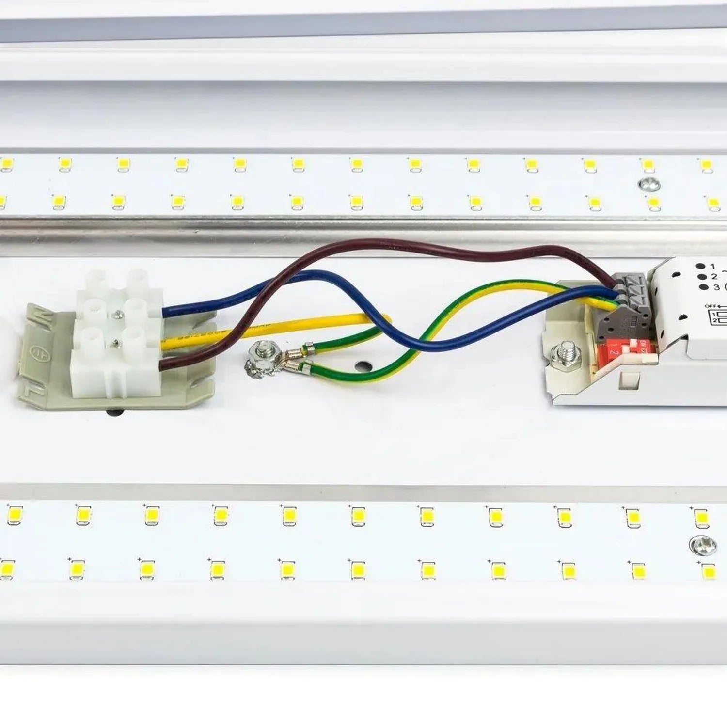 Installation shot of LED ceiling light showing wired electrical connectors and yellow LED modules mounted on white fixture fr
