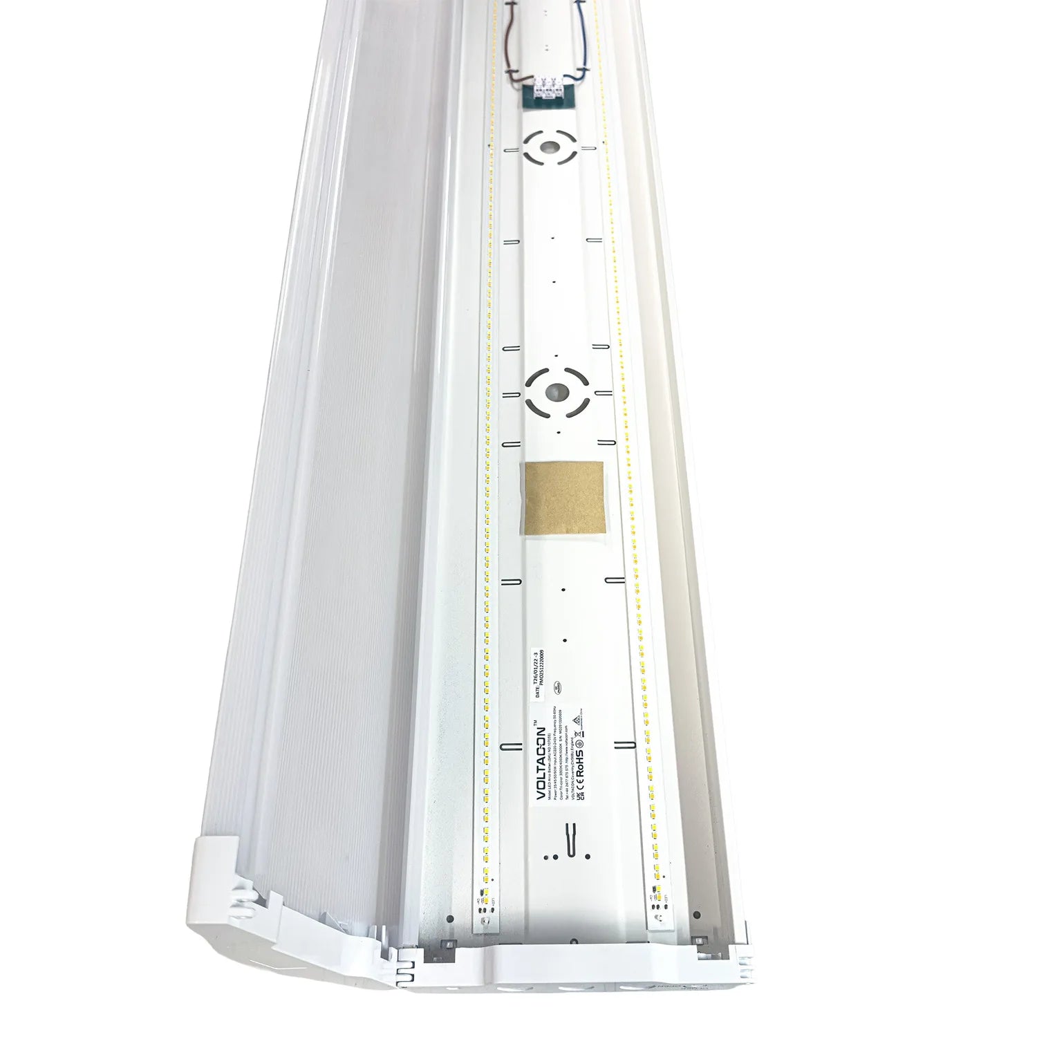 Top-down view of rectangular LED ceiling light with white frame, control markings, and gold panel detail.