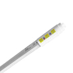 T8 LED tube with white casing and yellow warning labels showing safety certifications and sensor details on upper end.