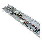 Interior view of LED batten light showing slim aluminum profile with power driver, wiring, and mounting hardware.