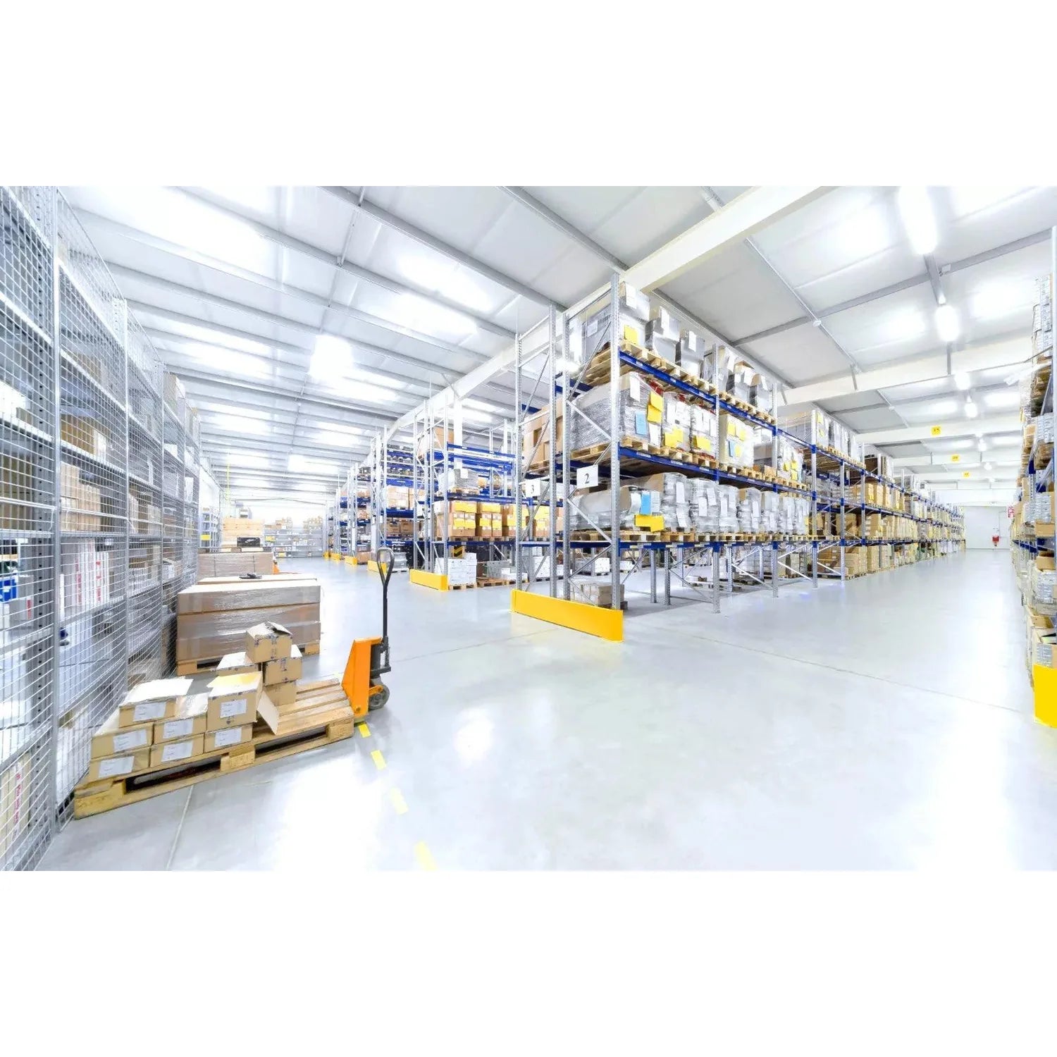 Modern warehouse interior with high bay LED lighting fixtures illuminating industrial shelving and storage racks.
