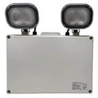 White rectangular emergency light unit with two black adjustable LED spotlights mounted on top, front view product photo.