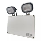 White emergency light unit with two adjustable black LED spotlights mounted on top, product label visible on lower panel.