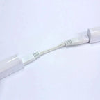 White LED under cabinet tube light with connector cable, angled view on light background