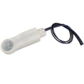 White cylindrical microwave motion sensor with attached black and blue wires, product displayed against plain background.