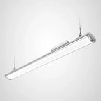 Sleek silver linear LED high bay light suspended by two cables against white background, product shot.