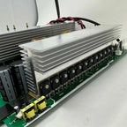 Main circuit board PCB assembly with aluminum heat sink, capacitors, transformers, and black connector terminals on green sub