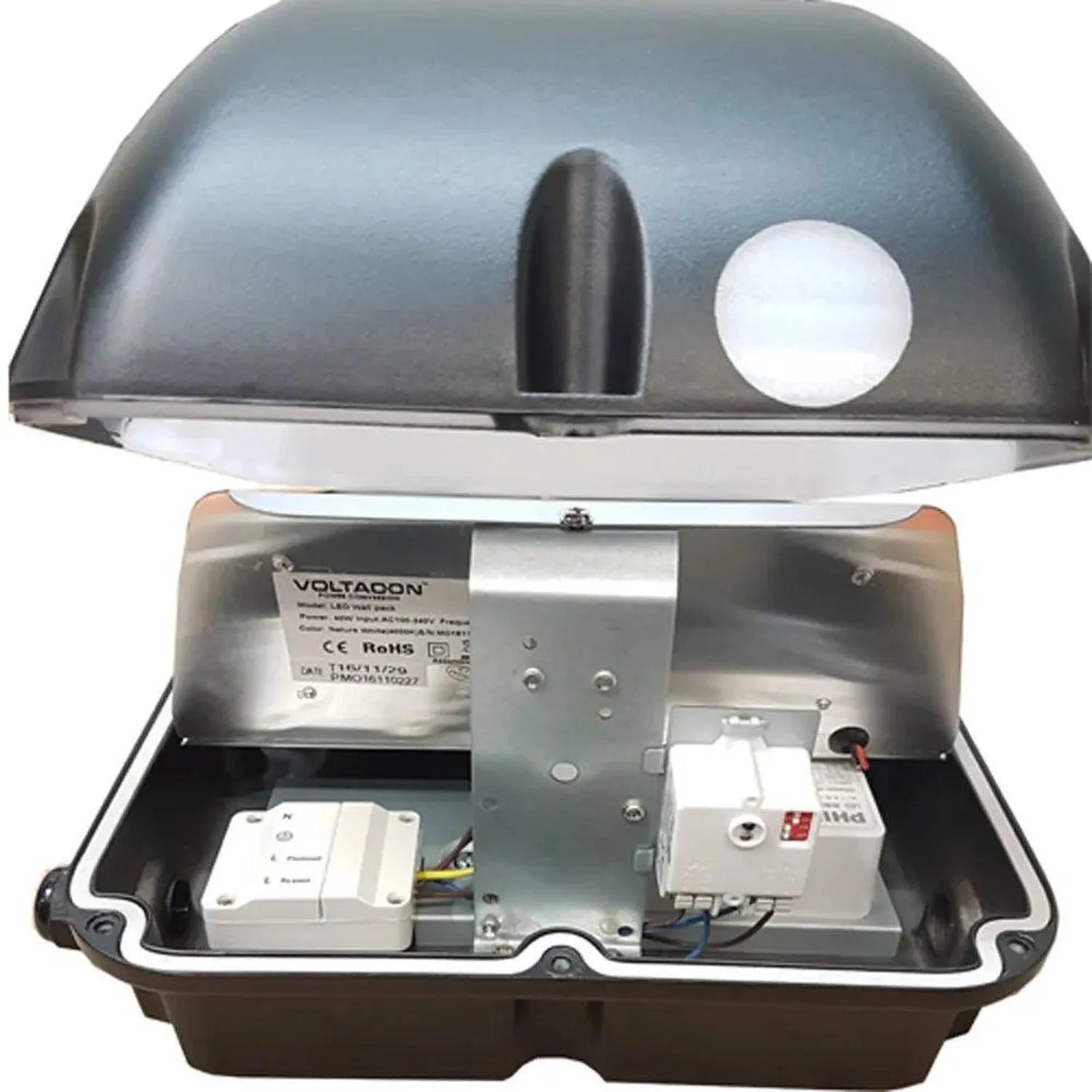 Voltacon LED wall pack disassembled showing dome housing, internal motor and electrical components including control modules 