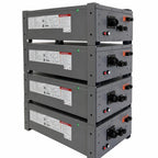 Four stacked gray battery modules with black connectors, orange switches, and red/white control buttons mounted on a steel fr