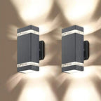Two black rectangular LED wall sconces with horizontal light bands, mounted on a neutral background with atmospheric lighting