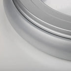 Close-up detail of silver metallic ceiling light fixture showing curved trim ring and smooth surface finish.