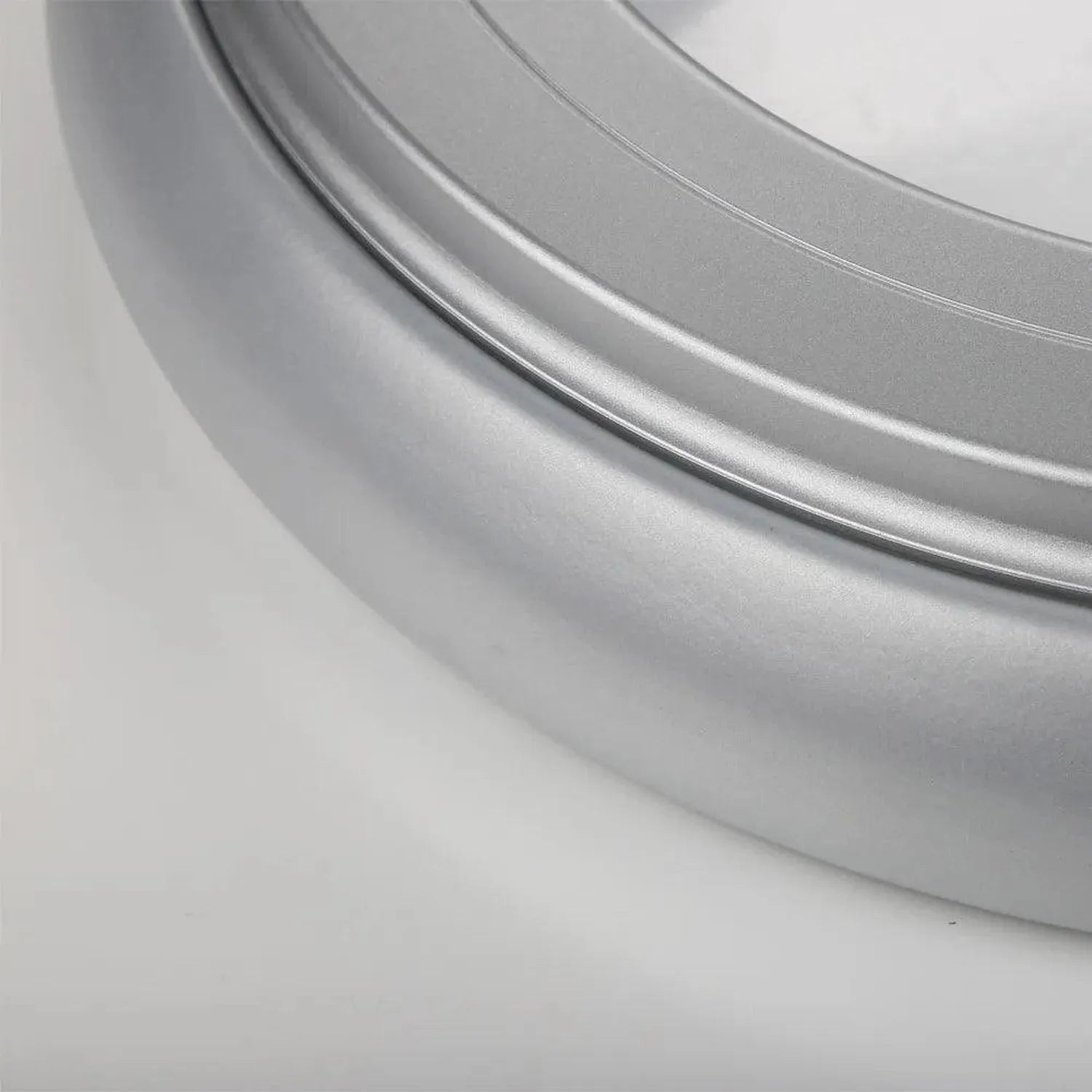 Close-up detail of silver metallic ceiling light fixture showing curved trim ring and smooth surface finish.