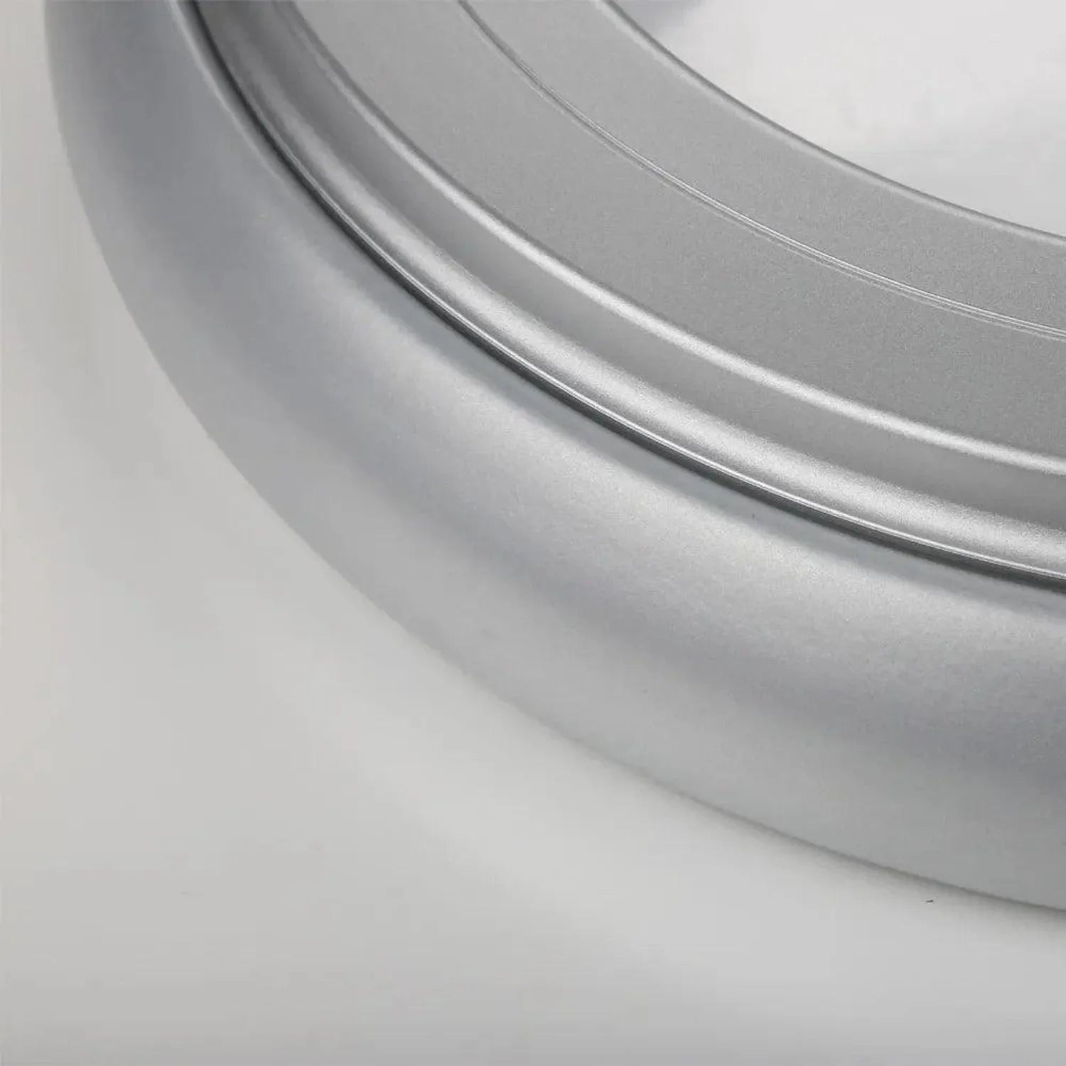 Close-up detail of sleek silver and grey circular LED ceiling light fixture with curved edge trim