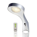White curved solar wall light with LED bulb shown alongside its remote control with green indicator buttons.