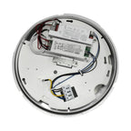 Interior view of round LED bulkhead light showing white ceiling canopy with dual driver modules, wiring, and mounting bracket