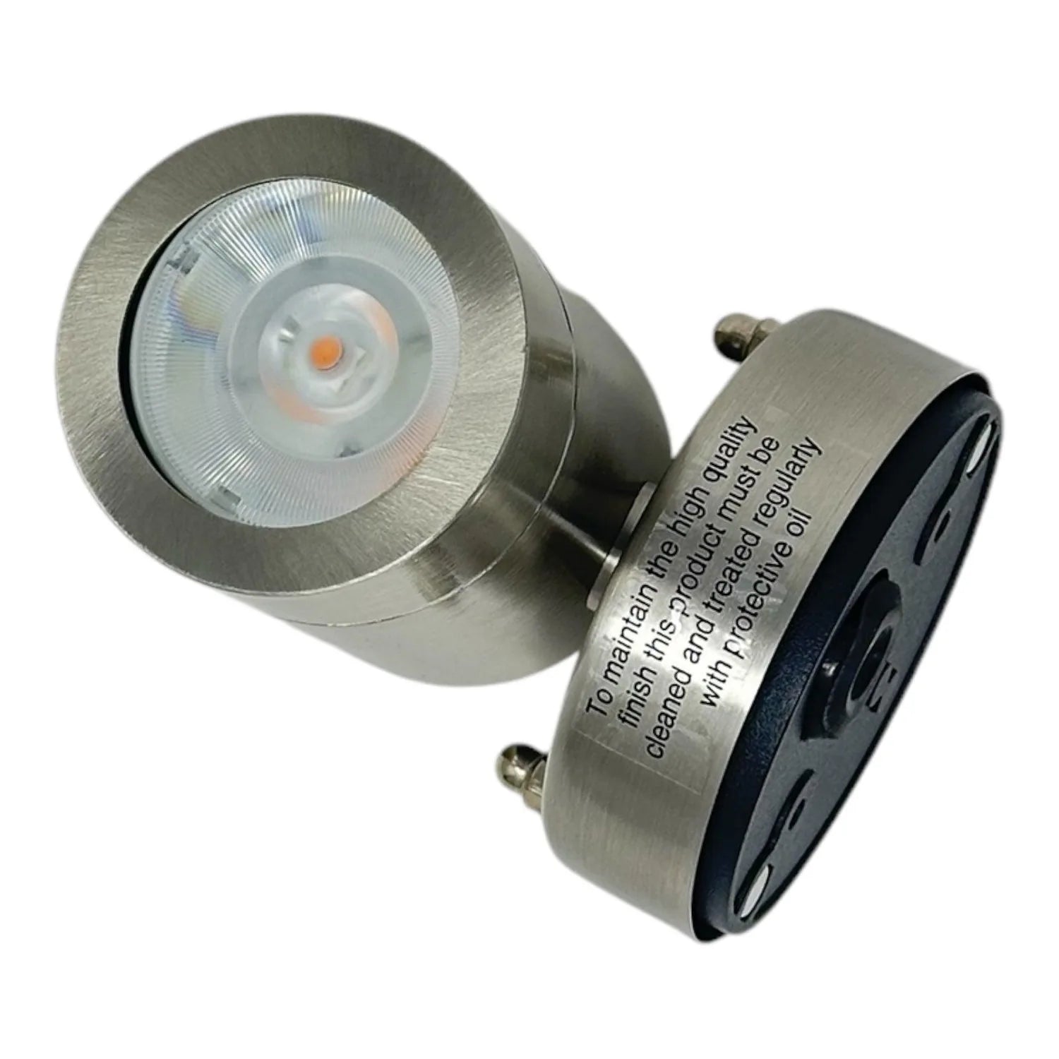 Brushed stainless steel LED spot light with recessed round faceplate and orange-tinted LED visible, shown at angle against wh