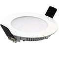 Round white LED recessed downlight with black connector terminal and spring clip visible on underside, isolated product shot.