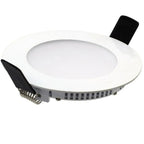 Round white LED recessed downlight with black connector terminal and spring clip visible on underside, isolated product shot.