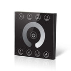 Black square DALI dimmer controller with central power button, four group selection buttons at top, and four scene buttons at