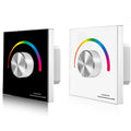 Two wall-mounted RGB LED dimmer controllers shown in black and white finishes, each featuring a metallic rotary knob surround