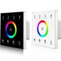 Two RGB touch panel remotes displayed side by side, one with black glass and one with white glass, each featuring a colorful 