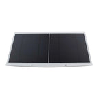 Foldable dual-panel solar charger with black photovoltaic cells and white frame, shown flat against white background.