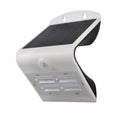 White solar LED wall light with motion sensor and four LED panels, mounted bracket visible.