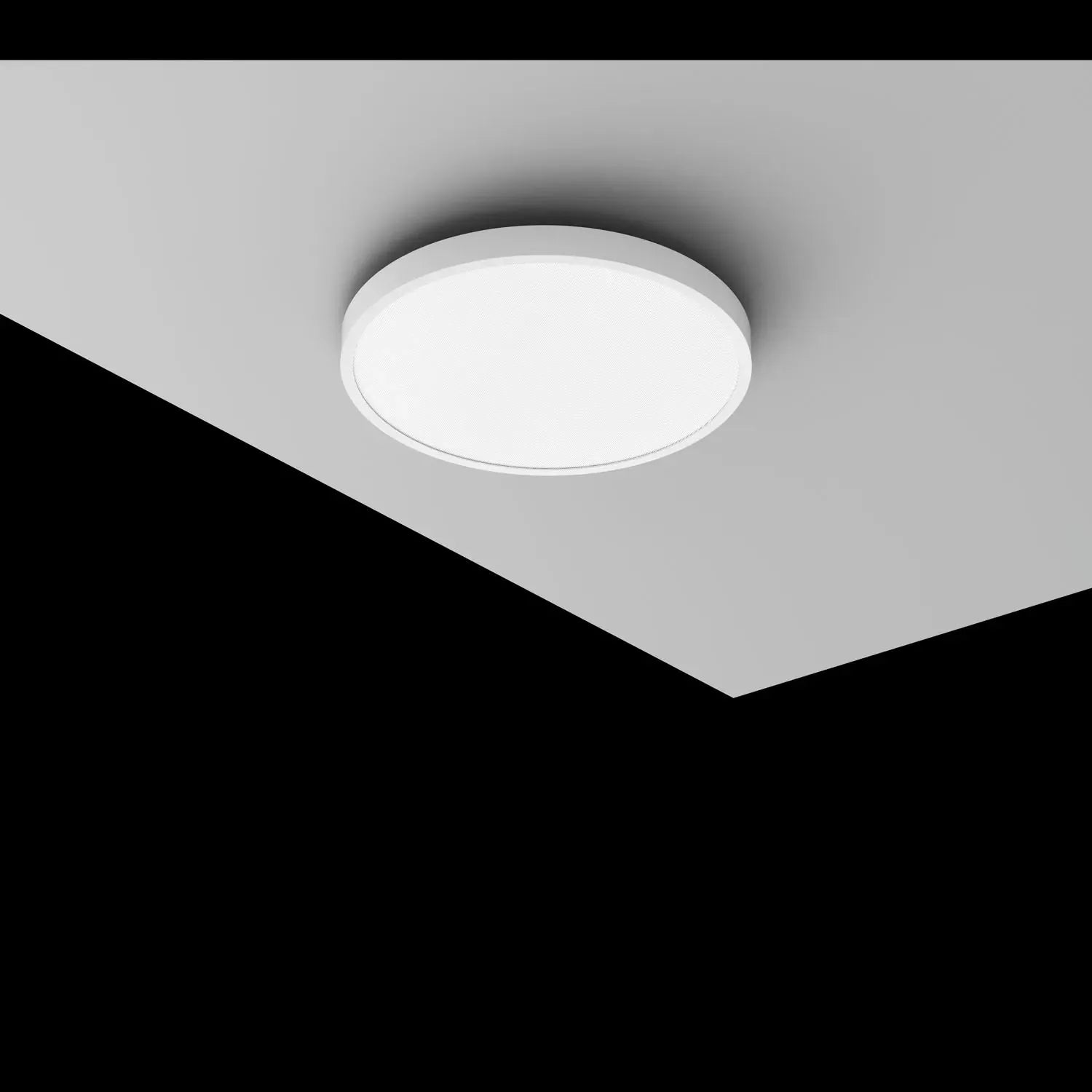 White circular surface-mounted ceiling light with recessed trim installed on gray drywall ceiling.