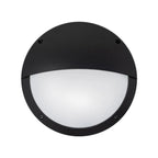 Black circular LED bulkhead light with white frosted lens and half-moon shade, mounted flush against white background.