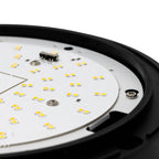 Close-up of LED bulkhead circuit board showing yellow SMD chips and electronic components mounted on white PCB with black hou
