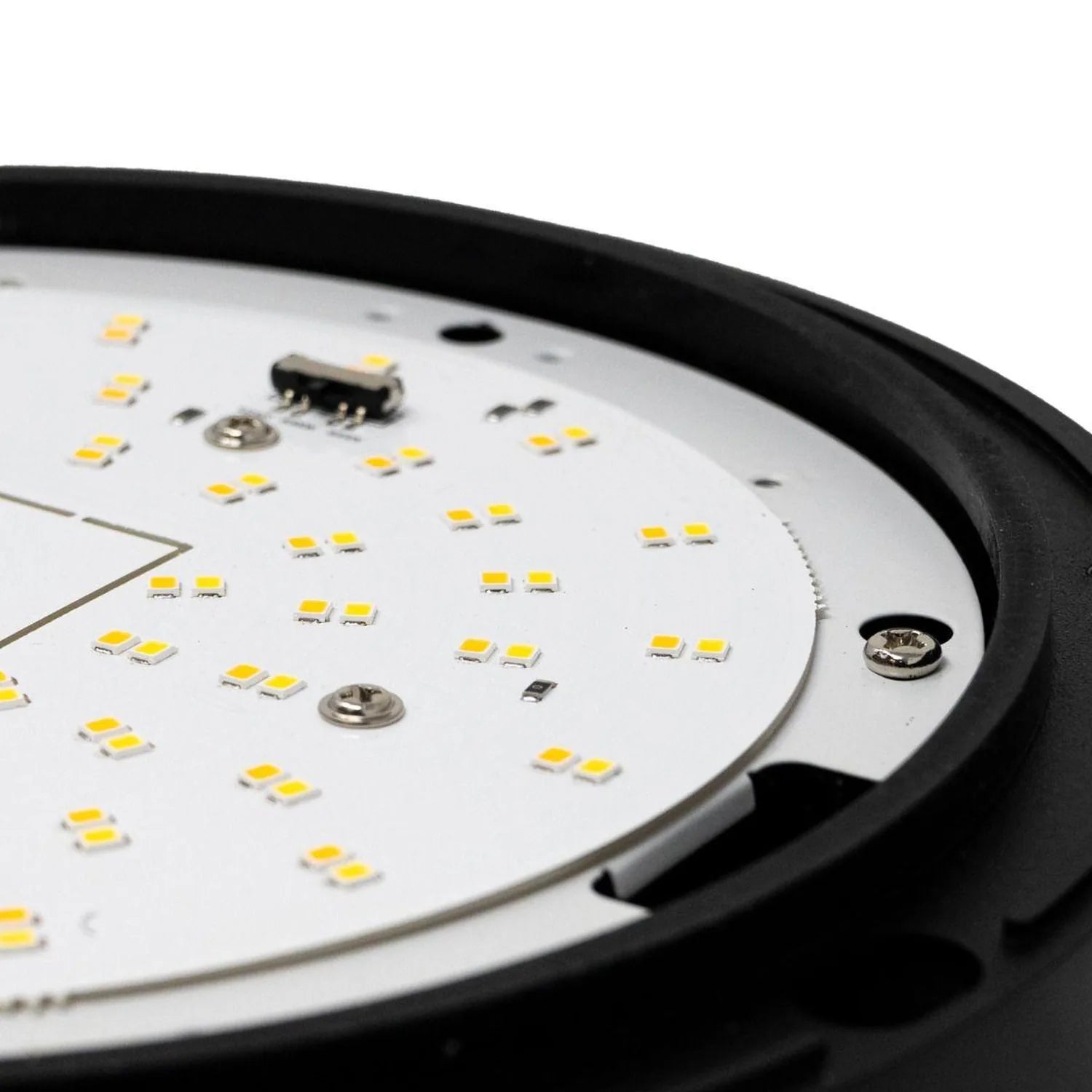 Close-up of LED bulkhead circuit board showing yellow SMD chips and electronic components mounted on white PCB with black hou