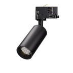 Black cylindrical LED track light with adjustable head mounted on track adapter, showing LED lens detail.