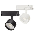 Black and white LED track lights with cylindrical heads and COB spotlights mounted on three-phase track rails, shown from ove