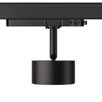 Black cylindrical LED track light fixture mounted on rail, showing connector head and adjustable positioning mechanism.