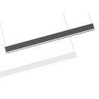 Two pendant light fixtures suspended by cables: dark gray uplight model above, white downlight model below, shown at angles.