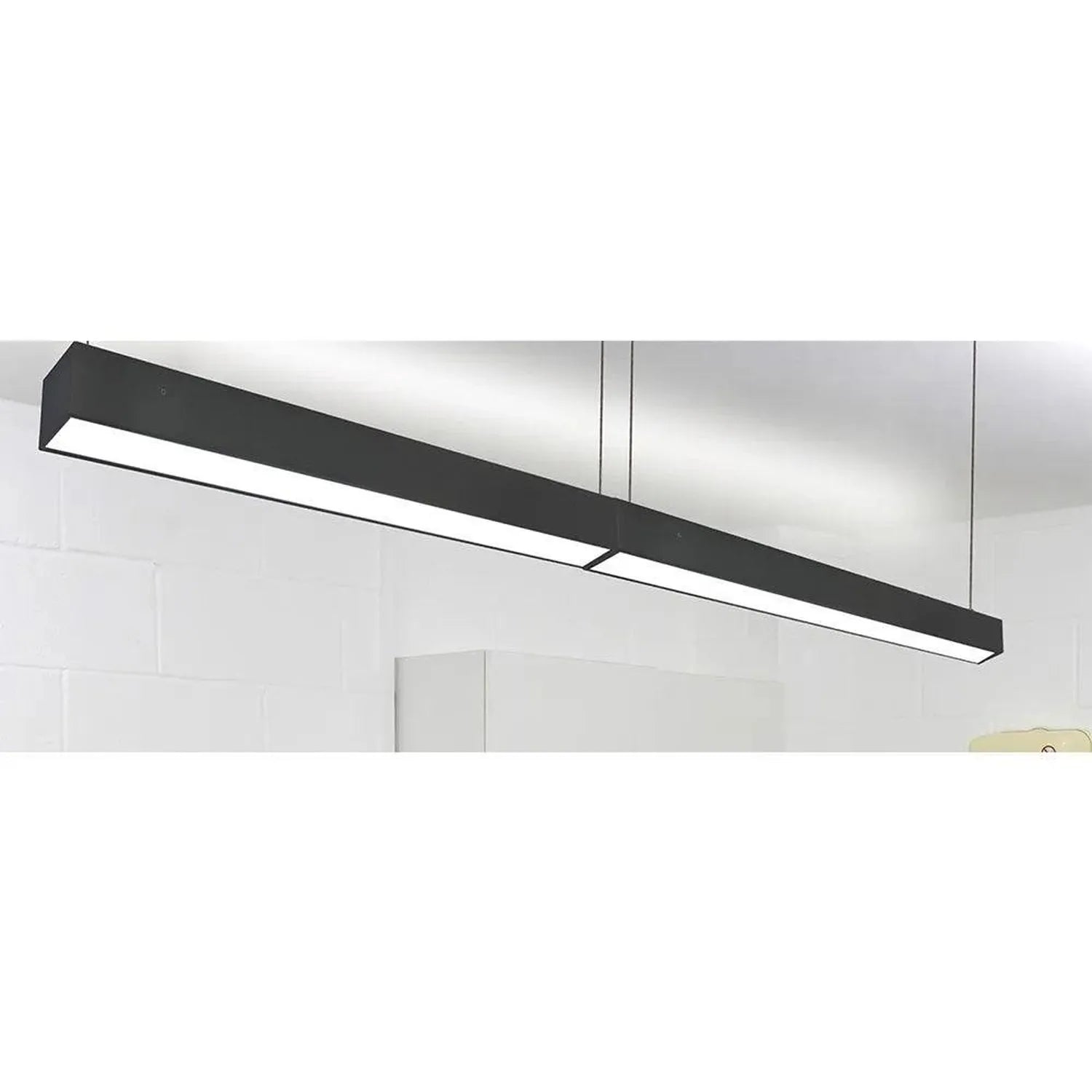 Black linear LED ceiling light fixture mounted horizontally against white ceiling and walls in installation shot.