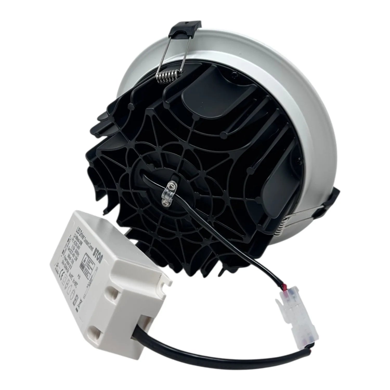 Disassembled LED downlight showing silver trim ring, black internal components with heat fins, and white driver unit with ele