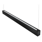 Black rectangular LED batten light with illuminated center strip, suspended by cables against white background.
