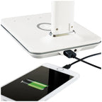 White LED desk lamp with integrated wireless charger, shown charging a smartphone with green battery indicator visible.